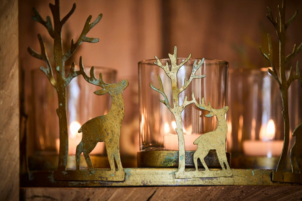 Close up of deer candle holder  with lit candles on a shelf