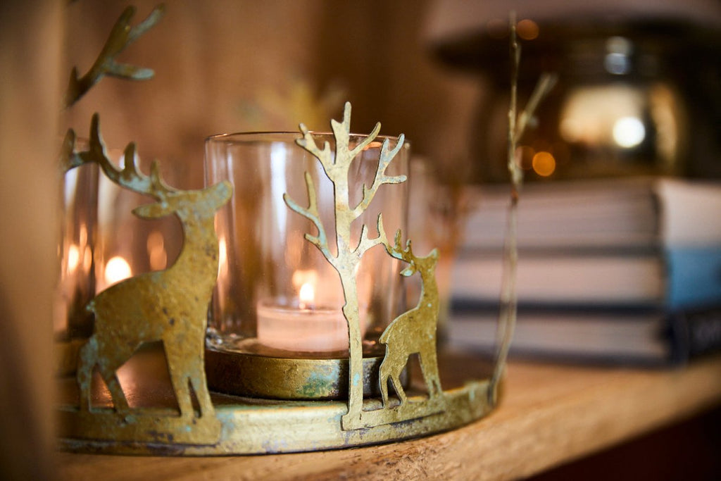 Close up of a deer themed candle holder on a shelf