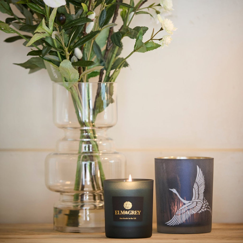 Crane Candle Holder beside a faux astrantia and elm and grey blue candle