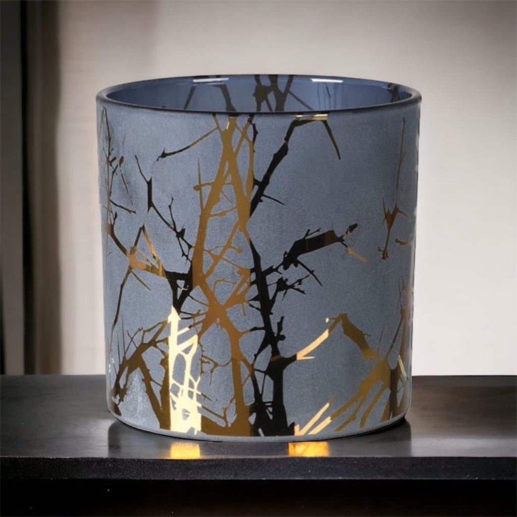 Black and gold candle holder on a  black marble surface