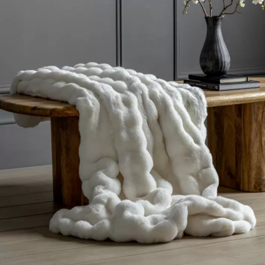 Marshmallow Cosy Throw on a bench in cream white