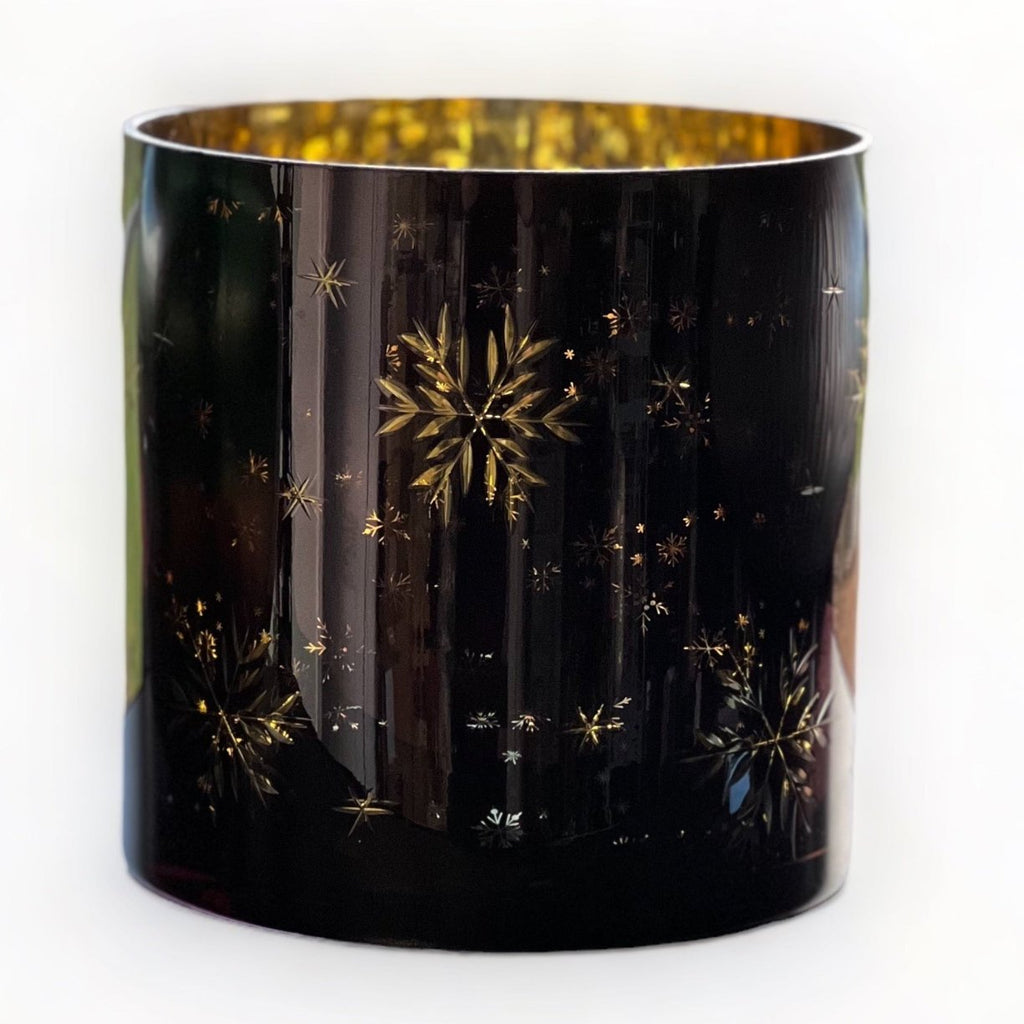 festive candle holders, adorned with snowflakes in varying sizes. Their glossy dark blue-black exterior finish paired with a shiny golden interior layer 