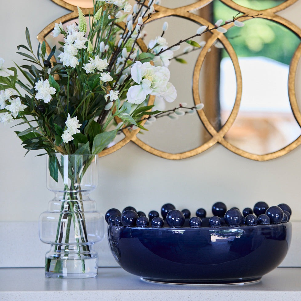 Navy Blue Bobble Bowl in kitchen next to white faux flower arrangement