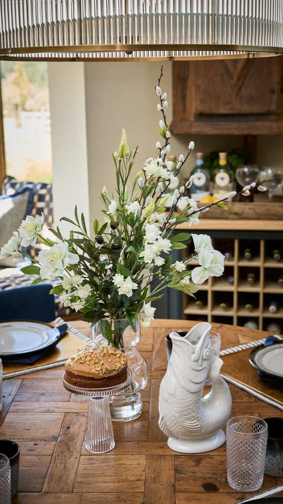 Kitchen scene with small ckae stand and gluggle jugs